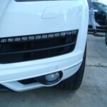 Before and after photographs of a damaged white, AUDI Quattro SUV that was repaired by Elite Paint & Body Shop in West Palm Beach, Florida.